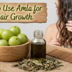 A blog banner graphic with a wooden sign at the top that reads "How to Use Amla for Hair Growth